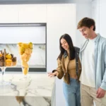 couple examining a marble kitchen island surface in a modern showroom