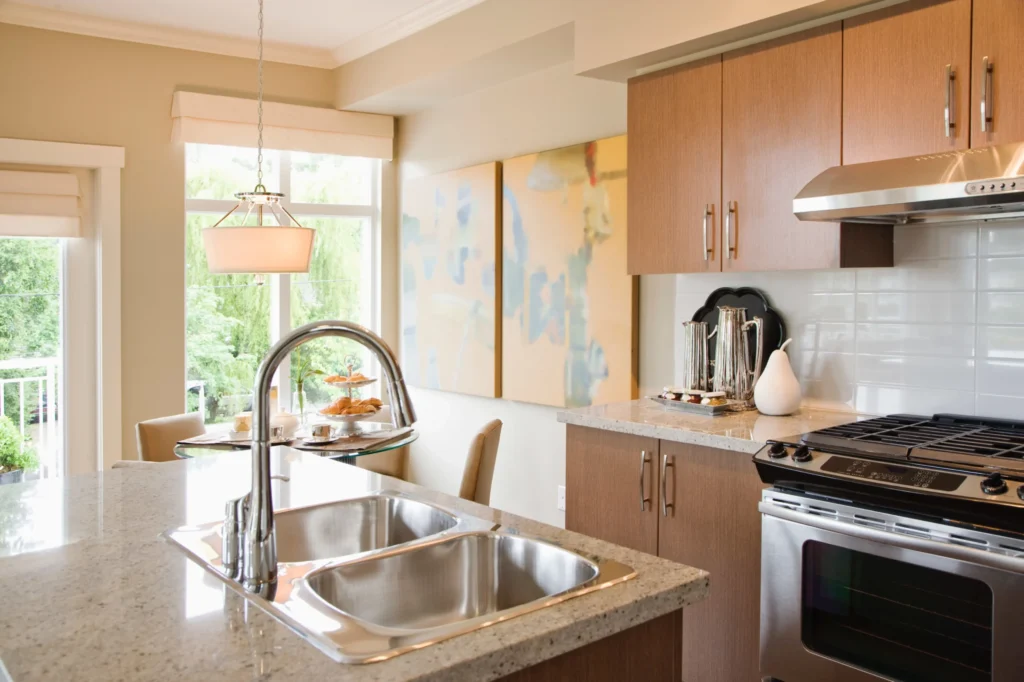 Quartz kitchen countertop with subtle gray veining and wooden cabinets