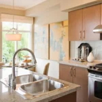 Quartz kitchen countertop with subtle gray veining and wooden cabinets