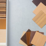 Selection of warm wood veneer samples in light, medium, and dark earthy tones for modern cabinet finishes.
