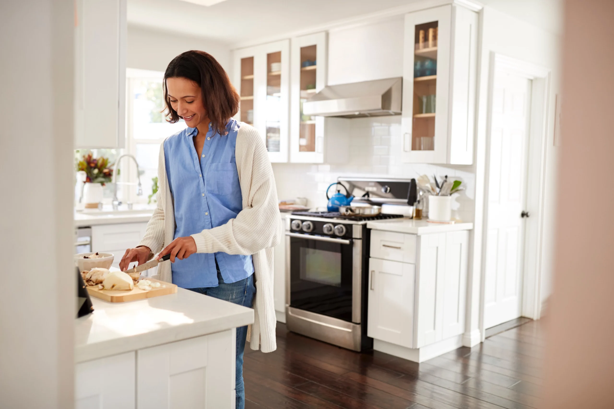 woman in modern kitchen using accurate measurements for renovation project