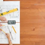 engineers preparing kitchen measurement plans with tools, drawings, and digital sketches